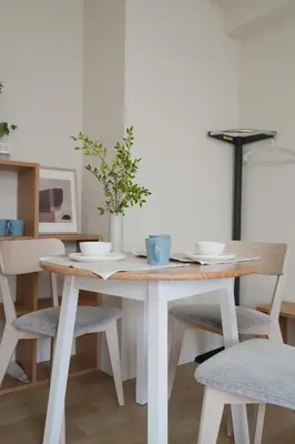 a dining room table with two chairs and a table with a plant on it at Ikeda Ueno 501 Quad room Room in Tokyo