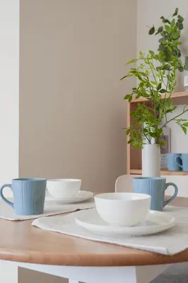 a dining room table with plates and bowls on it at Ikeda Ueno 501 Quad room Room in Tokyo