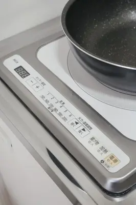 a stove top with a pan on top of it at Ikeda Ueno 501 Quad room Room in Tokyo