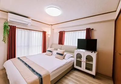 a bedroom with a bed with a tv on it at \u697d\u697d\u6c11\u6cca in Tokyo