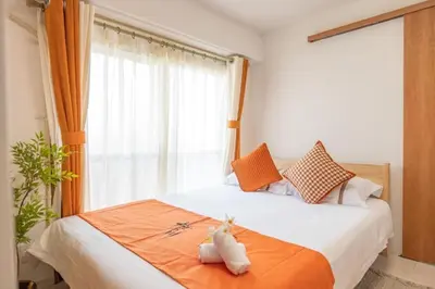 a bed with two stuffed animals sitting on top of it at \u697d\u697d\u6c11\u6cca in Tokyo