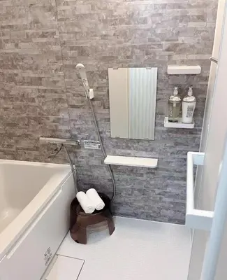 a bathroom with a tub and a sink and a mirror at \u697d\u697d\u6c11\u6cca in Tokyo