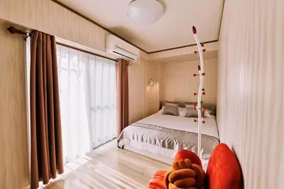 a bedroom with a bed and a large window at \u697d\u697d\u6c11\u6cca in Tokyo