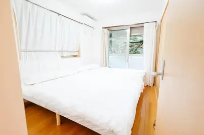 a bed in a room with a window at T akadababa subway 4 mins walk! Newly building \u65b0\u7bc9! \u9ad8\u7530\u99ac\u5834\u99c5 \u5f92\u6b69\u570f\u5185\u5927\u4eba\u6c17! Shinjuku\u65b0\u5bbf\u5708!\u9ad8\u901f\u65e0\u9650\u5236202 in Tokyo