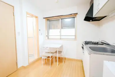 a small kitchen with a table and a sink at T akadababa subway 4 mins walk! Newly building \u65b0\u7bc9! \u9ad8\u7530\u99ac\u5834\u99c5 \u5f92\u6b69\u570f\u5185\u5927\u4eba\u6c17! Shinjuku\u65b0\u5bbf\u5708!\u9ad8\u901f\u65e0\u9650\u5236202 in Tokyo
