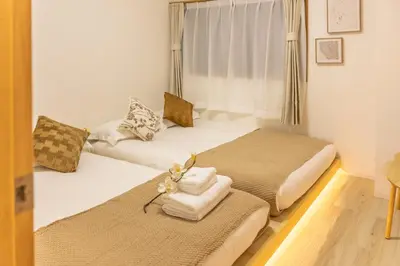 a room with two beds with towels and a window at Near Shinjuku,3LDK Mansion,3bedrooms,12 people in Tokyo