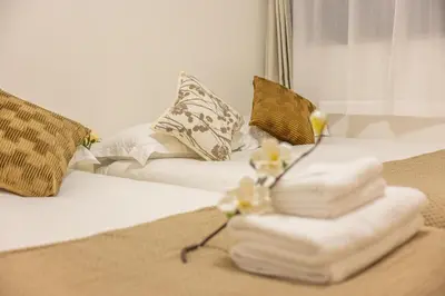 a pile of folded towels on a bed with a couch at Near Shinjuku,3LDK Mansion,3bedrooms,12 people in Tokyo