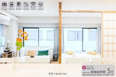 a living room with white furniture and large windows at Mi-HOTEL UENO in Tokyo