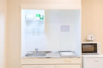 a kitchen with a sink and a microwave at Mi-HOTEL UENO in Tokyo