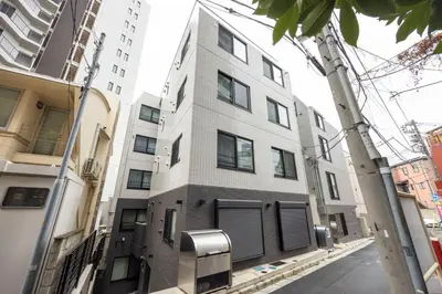a tall building with a parking meter in front of it at \u30aa\u30fc\u30af\u30ec\u30b9\u30c8\u6075\u6bd4\u5bff in Tokyo