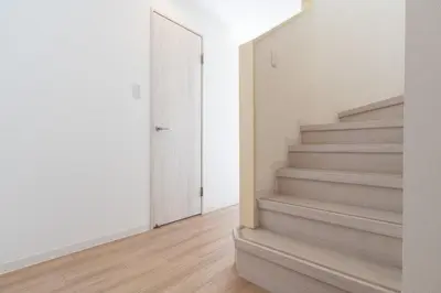 a hallway with stairs in a home with white walls at DeLCCS\u8981\u753a in Tokyo
