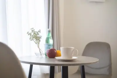 a table with a cup and fruit and a bottle at Bel Avenir in Tokyo