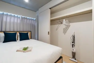 a bedroom with a bed with a book on it at Bel Avenir in Tokyo