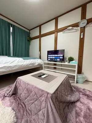 a bedroom with a table with a laptop on it at \u6c60\u888b\u99c5\u5f92\u6b69OK \u65b0\u5bbf\u99c524\u5206 \u6771\u4eac\u306e\u89b3\u5149\u540d\u6240\u3078\u306e\u30a2\u30af\u30bb\u30b9\u826f\u597d NINJA\u5c4b\u6577\u306e\u6587\u5316\u4f53\u9a131k in Tokyo
