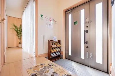 a hallway with a door and a shelf of wine bottles at Mori house\u738b\u5b50\u672c\u753a in Tokyo