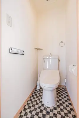 a bathroom with a toilet and a checkered floor at Mori house\u738b\u5b50\u672c\u753a in Tokyo