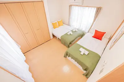 a small room with two beds and a window at Mori house\u738b\u5b50\u672c\u753a in Tokyo