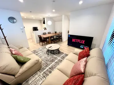 a living room with a couch and a table at Ochiai Open House in Tokyo