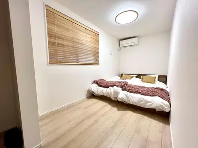 a bedroom with a bed and a window at Ochiai Open House in Tokyo