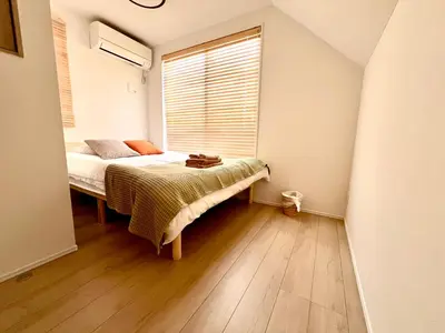 a bedroom with a bed and a window at Ochiai Open House in Tokyo