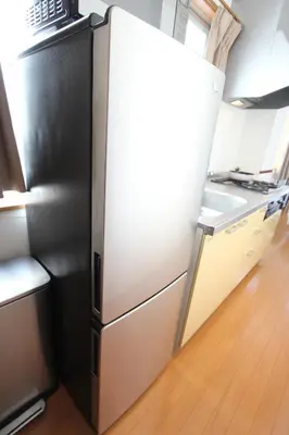 an open refrigerator in a kitchen with a counter at HOTEL LUANA in NISHIKI in Tokyo