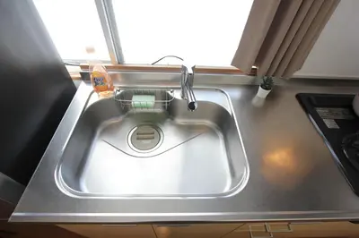 a sink in the middle of a kitchen at HOTEL LUANA in NISHIKI in Tokyo
