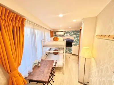 a small room with a bunk bed and a table at Ikebukuro-Kanamecho Studio Comfortable&Central 2F in Tokyo