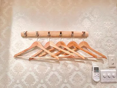 a wooden rack with wooden hangers on a wall at Ikebukuro-Kanamecho Studio Comfortable&Central 2F in Tokyo