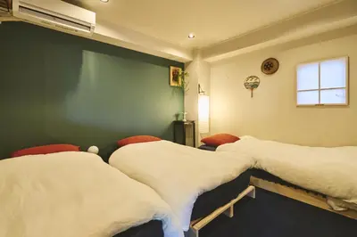 a hospital room with two beds and a window at HOTEL HONjoy in Tokyo