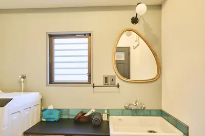 a bathroom with a sink and a mirror at HOTEL HONjoy in Tokyo