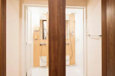 a bathroom with a shower and a toilet and a mirror at 3 Mins from Skytree and Train Station, A Dream Retreat For 8 in Tokyo