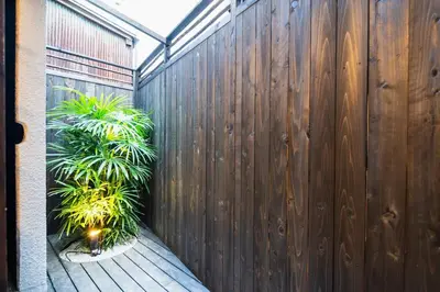 a wooden fence with plants on a wooden deck at 3 Mins from Skytree and Train Station, A Dream Retreat For 8 in Tokyo