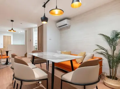 a living room with a table and a couch at \u6839\u5cb8\u6238\u5efa\u3066 in Tokyo