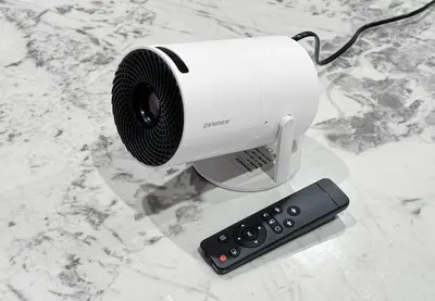 a white camera and a remote control on a counter at \u6839\u5cb8\u6238\u5efa\u3066 in Tokyo
