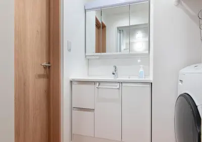 a bathroom with a sink and a washing machine at \u6839\u5cb8\u6238\u5efa\u3066 in Tokyo