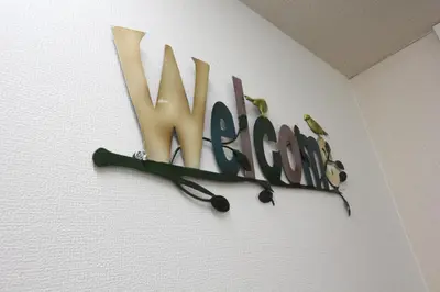 a sign with two birds on a wall at LUANA in SHIN-KOUENJI in Tokyo