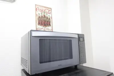a microwave oven sitting on top of a table at LUANA in SHIN-KOUENJI in Tokyo