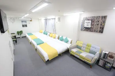 a hospital room with two beds and a couch at LUANA in SHIN-KOUENJI in Tokyo