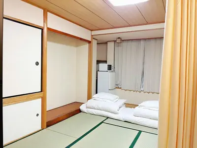a small room with two beds and a window at hananosato \u9ad8\u7530\u99ac\u5834 in Tokyo