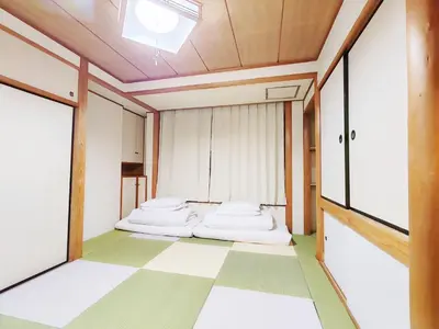 a room with two beds and a window at hananosato \u9ad8\u7530\u99ac\u5834 in Tokyo
