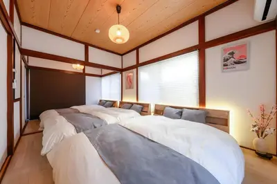 a row of four beds in a room at Tokyo East Hotel in Tokyo