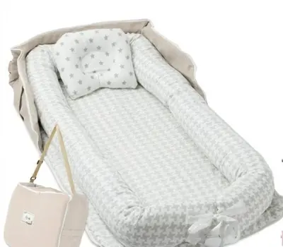 a baby crib with a blanket and a purse at Tokyo East Hotel in Tokyo