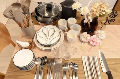 a wooden table with plates and utensils on it at Tokyo East Hotel in Tokyo