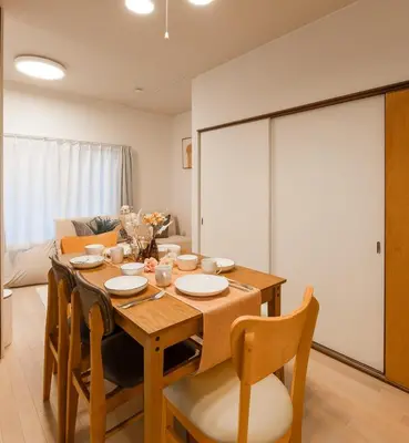 a dining room with a wooden table and chairs at Tokyo East Hotel in Tokyo