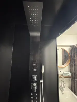 a bathroom with a shower and a sink and a mirror at \u30cd\u30ae\u30cf\u30a6\u30b9,Negi House with Retro Vibes in Shopping Street,Group Friendly in Tokyo