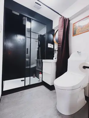 a bathroom with a white toilet and a shower at \u30cd\u30ae\u30cf\u30a6\u30b9,Negi House with Retro Vibes in Shopping Street,Group Friendly in Tokyo