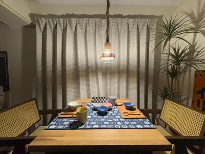 a dining room table with a blue and white table cloth at \u30cd\u30ae\u30cf\u30a6\u30b9,Negi House with Retro Vibes in Shopping Street,Group Friendly in Tokyo