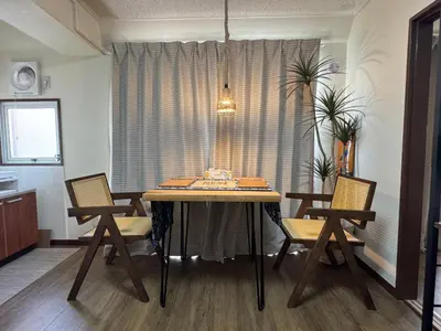 a dining room with a table and two chairs at \u30cd\u30ae\u30cf\u30a6\u30b9,Negi House with Retro Vibes in Shopping Street,Group Friendly in Tokyo
