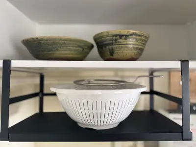 a shelf with three bowls on top of it at \u30cd\u30ae\u30cf\u30a6\u30b9,Negi House with Retro Vibes in Shopping Street,Group Friendly in Tokyo