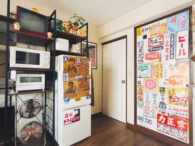 a kitchen with a refrigerator covered in magnets and a microwave at \u30cd\u30ae\u30cf\u30a6\u30b9,Negi House with Retro Vibes in Shopping Street,Group Friendly in Tokyo